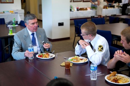 2015 Law Enforcement Explorers Conference man converses with two explorers during meal