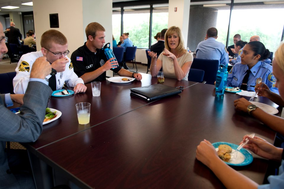 2015 Law Enforcement Explorers Conference woman talks during meal while explorers listen