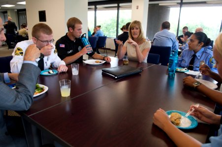 2015 Law Enforcement Explorers Conference woman talks during meal while explorers listen