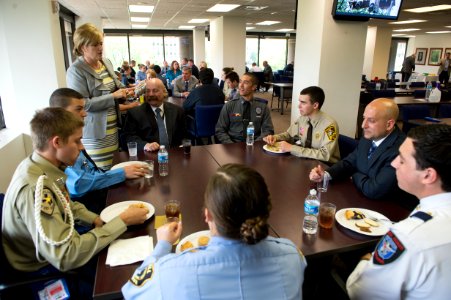 2015 Law Enforcement Explorers Conference woman stands at table during dessert