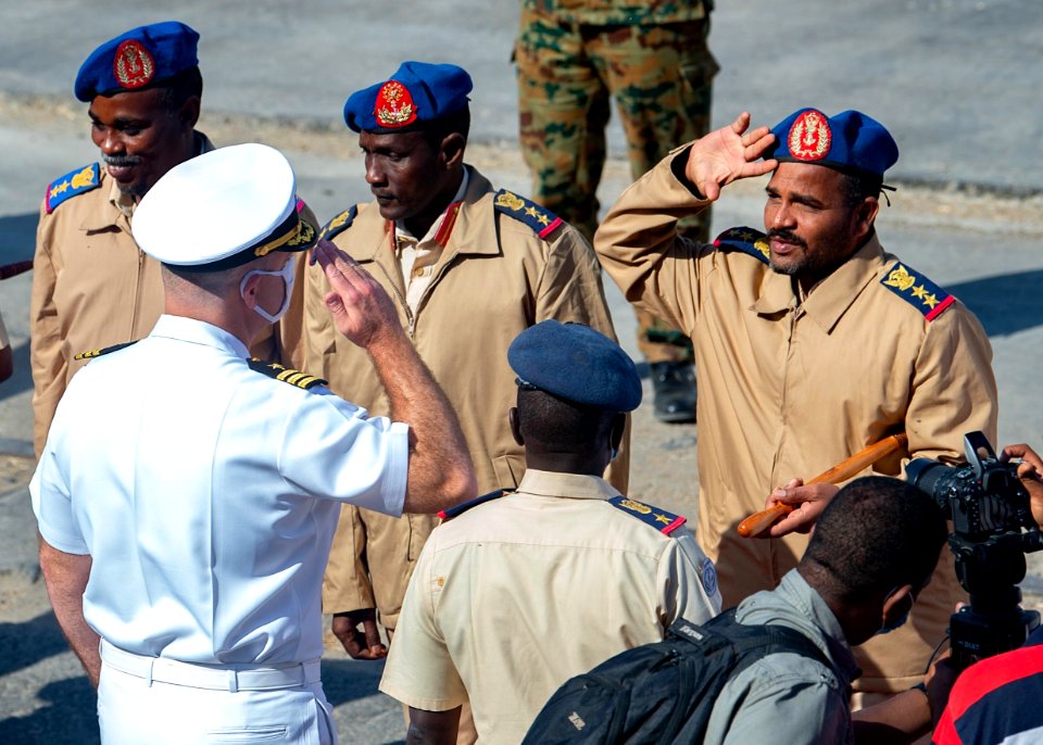 210301-N-PS962-1146 Cmdr. Timothy Shanley greets official party during a scheduled port visit in Port Sudan, Sudan
