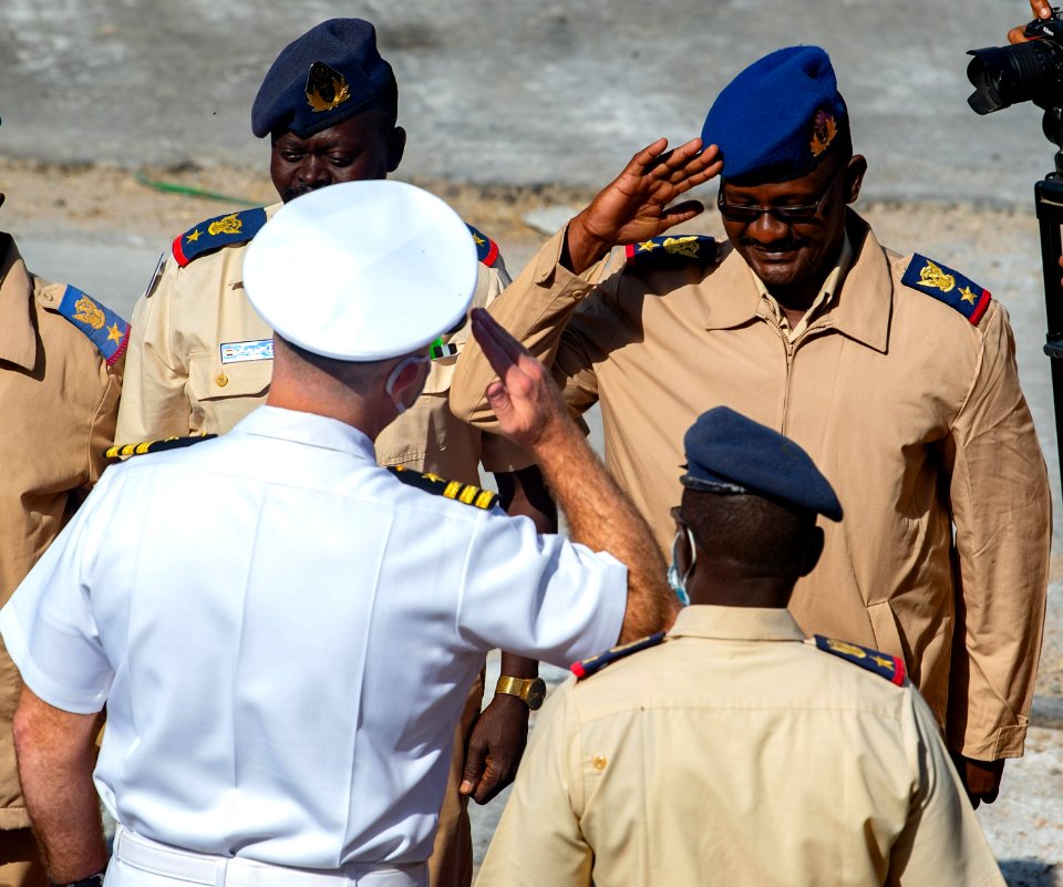 210301-N-PS962-1176 Cmdr. Timothy Shanley greets official party during a scheduled port visit in Port Sudan, Sudan
