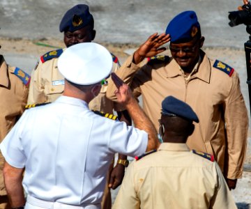 210301-N-PS962-1176 Cmdr. Timothy Shanley greets official party during a scheduled port visit in Port Sudan, Sudan