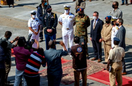 210301-N-PS962-1194 Cmdr. Timothy Shanley poses for photos with the official party during a scheduled port visit in Port Sudan, Sudan