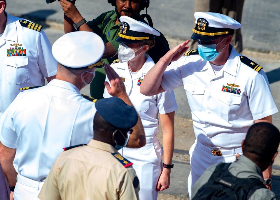 210301-N-PS962-1158 Cmdr. Timothy Shanley greets official party during a scheduled port visit in Port Sudan, Sudan