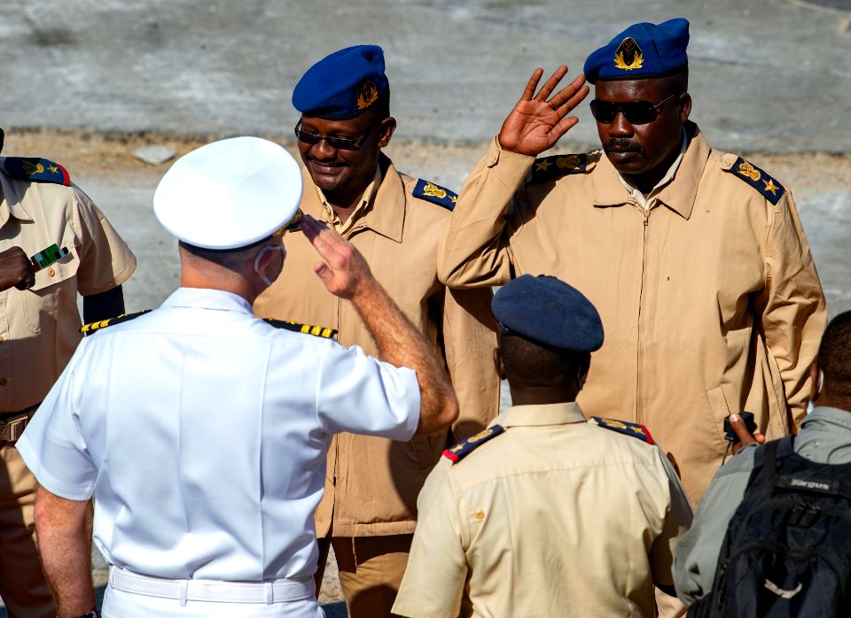 210301-N-PS962-1179 Cmdr. Timothy Shanley greets official party during a scheduled port visit in Port Sudan, Sudan