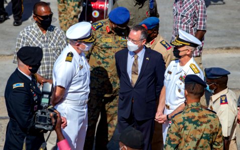 210301-N-PS962-1200 Cmdr. Timothy Shanley greets official party during a scheduled port visit in Port Sudan, Sudan