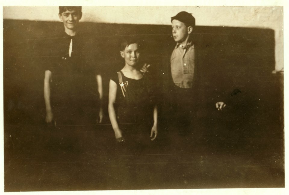 3 Boys going to work at 1 P.M. May 21, 1909. Photo taken in outer hall of spinning room of one of the mills of Amoskeag Mfg. Co., Manchester, N.H., where I found them working. Smallest boy LOC nclc.01783