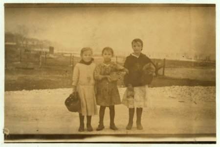 3 of the many young oyster shuckers going home from the Pass Christian Cannery at 5 P.M. Lena Krueger, 7 years old (in the middle) had shucked 6 pots that day; Annie Kadeska, 9 years old on LOC nclc.01039