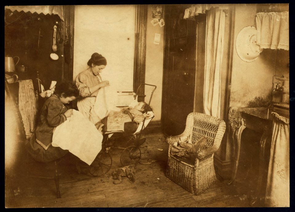 309 W. 146th Street. (...) and her seven year old daughter, Lorenza, embroidering ladies waists in their dirty kitchen-living room. Lorenza makes the stems of the flowers. Her mother said, LOC nclc.05487