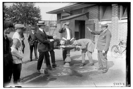 4 men near drinking fountain in park LCCN2014710845