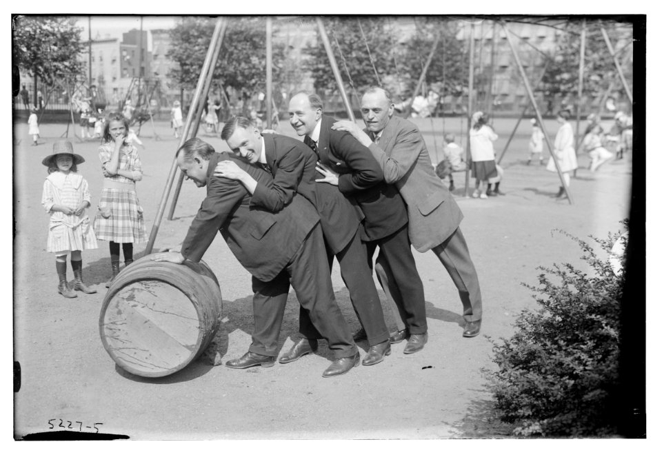 4 men rolling barrel in park LCCN2014710844