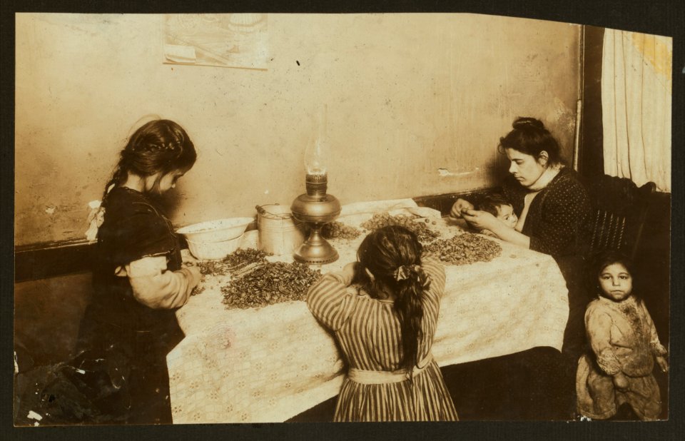 4-30 P.M. Mrs. Annie De Maritius, 46 Laight St., front, Nursing a dirty baby while she picks nuts. Was suffering with a sore throat. Rosie, 3 yrs. old hanging around. Conevieve, 6 yrs. old. LOC cph.3b36704