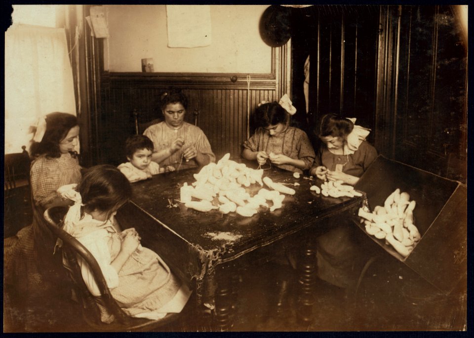 5 P.M. Making dolls legs for Campbell Kids. Cattena family, 71 Sullivan St., 5(th) floor front. As soon as the photo was taken, Rose carried the box full of finished legs to the Aetna Doll LOC nclc.04143