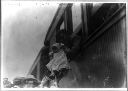 69th Regiment, New York National Guard, departing for Texas- soldier holding baby from train window LCCN2016651314