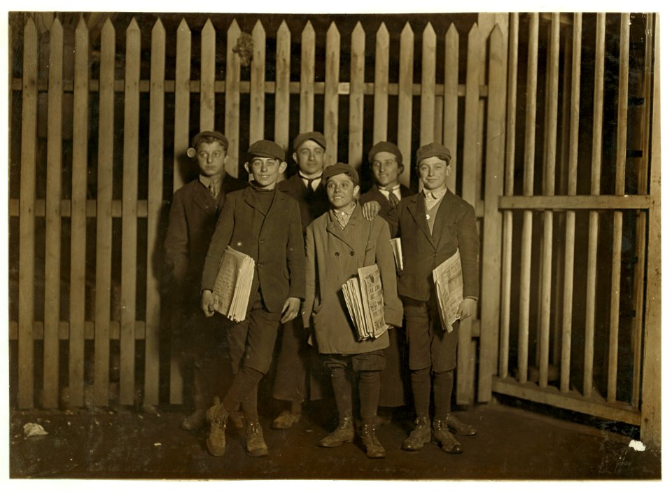 7-00 P.M. Boys selling papers at the depot, Bridgeport, Conn. Smallest one has been selling for 8 years. LOC nclc.03285
