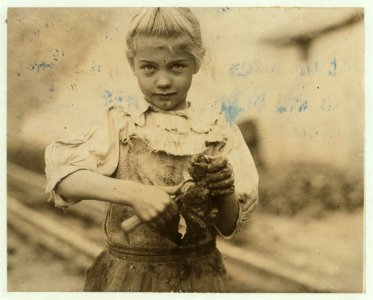 7-year old Rosie. Regular oyster shucker. Her second year at it. Illiterate. Works all day. Shucks only a few pots a day. (Showing process) Varn & Platt Canning Co. LOC nclc.01015 photo