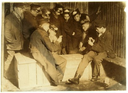 8-00 P.M. Flashlight photo of messengers absorbed in their usual Poker game in the 'Den of the Terrible Nine' (the waiting room for Wes. Union Messengers, Hartford, Conn.) They play for LOC cph.3c21885