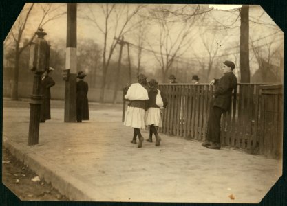 8-30 A.M., Nov. 12, 1912. Two young girls, Murry and Westover, carrying home sacks full of hose-supporters for home work, from American Narrow Fabric Co., Worcester, Mass. Loads are heavy LOC nclc.04288