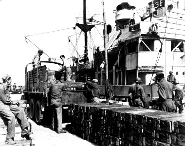 80-G-247134 Dutch coaster, Theseus, unloads ammunition at port of Roscoff