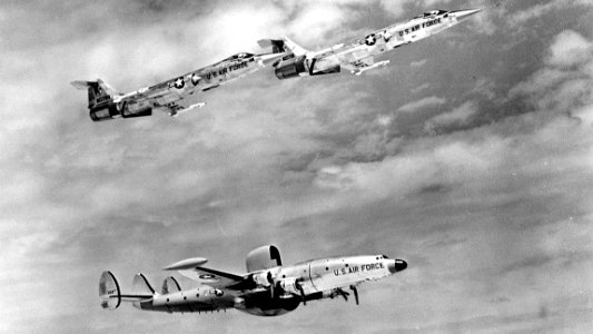 83d Fighter-Interceptor Squadron F-104As escort a Lockheed EC-121