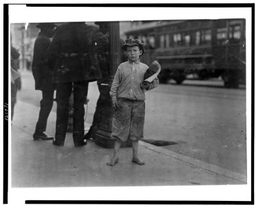 9 year old newsboy selling near Southern Pacific Depot. A negro bystander said- 'He's de boss fighter of 5th Street.' See California report. LOC cph.3c21071