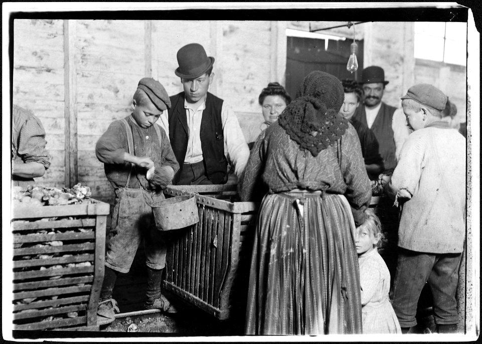 9 year old Johnnie and the shucking boss. He is also a padrone. For four years he has brought these people from... - NARA - 523419