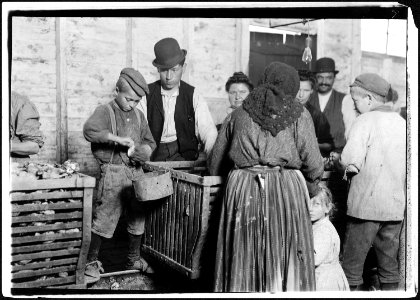 9 year old Johnnie and the shucking boss. He is also a padrone. For four years he has brought these people from... - NARA - 523419