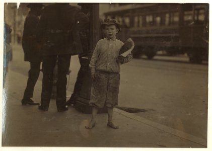 9 year old newsboy selling near Southern Pacific Depot. A negro bystander said- 'He's de boss fighter of 5th Street.' See California report. LOC cph.3c21071