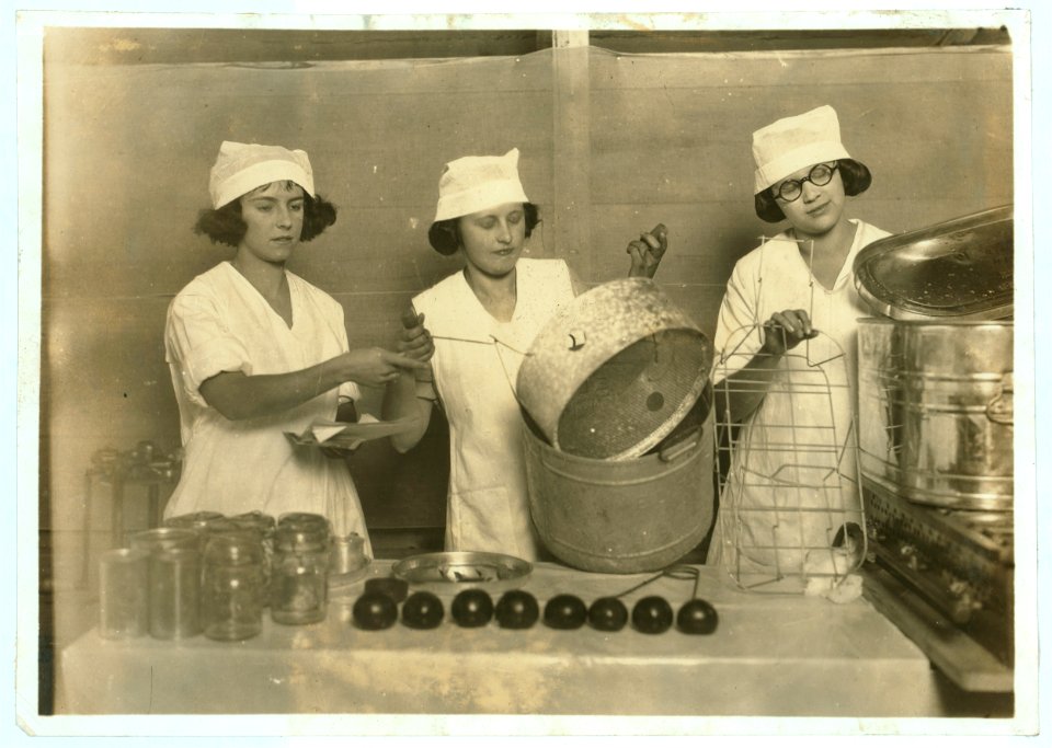 A 'Demonstration team' composed of three prize-winning Cabell County girls. They are showing the visitors at the Fair how team work makes for efficiency in canning their farm products. State LOC nclc.04385
