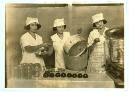 A 'Demonstration team' composed of three prize-winning Cabell County girls. They are showing the visitors at the Fair how team work makes for efficiency in canning their farm products. State LOC nclc.04385