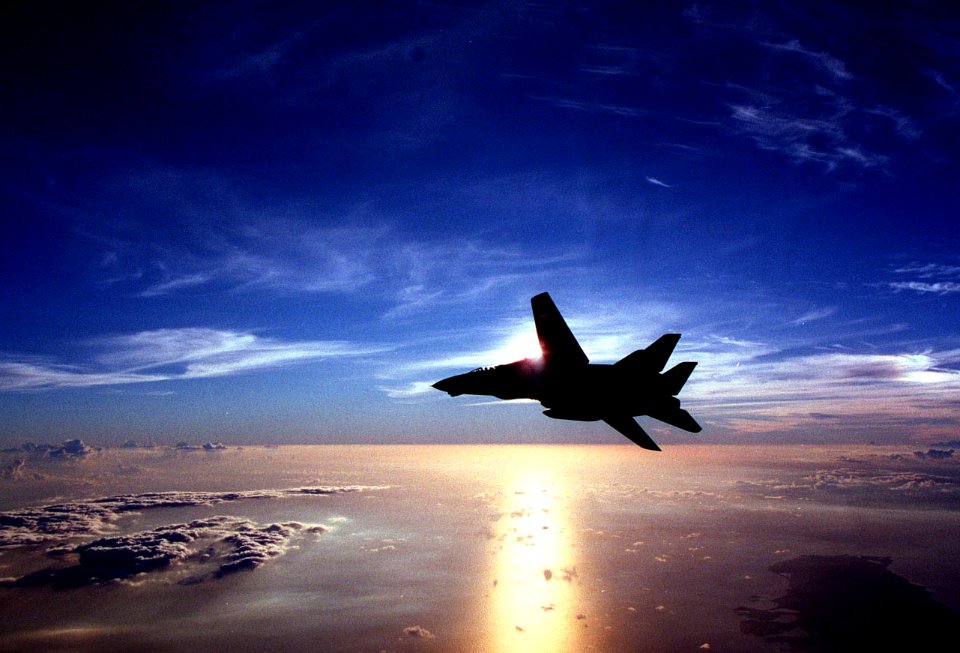961210-N-5502T-001 F-14 Flying at Sun Set