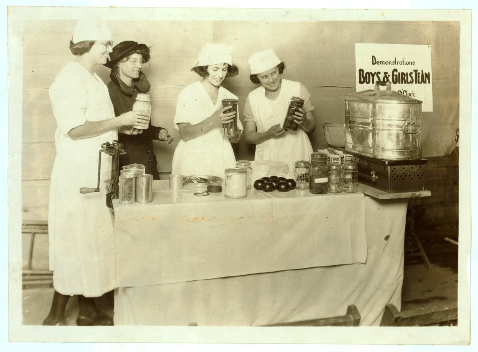 A 'Demonstration team' composed of three prize-winning Cabell Co. girls. They are showing the visitors at the Fair how team work makes for efficiency in canning their farm products. State 4 LOC nclc.04387