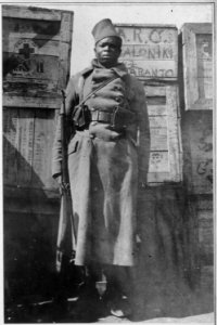 A . . . Negro sentry guarding American Red Cross supplies in Salonica (sic), Greece. - NARA - 533592