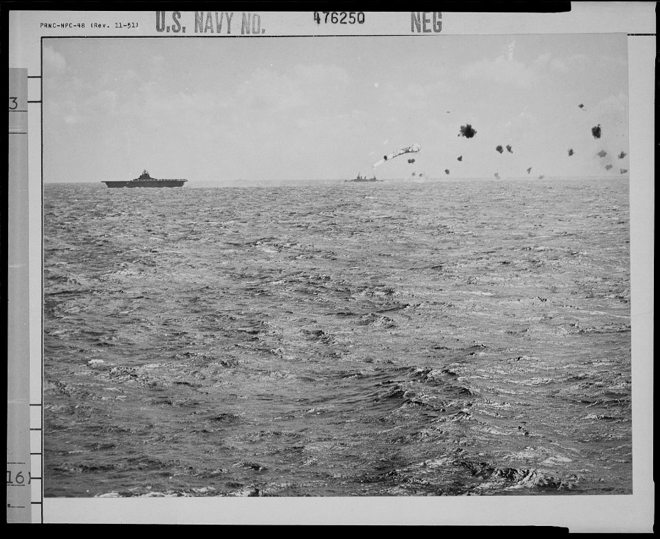 A burning Japanese torpedo-bomber falls after being knocked down by artillery from American warships. - NARA - 520983