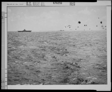 A burning Japanese torpedo-bomber falls after being knocked down by artillery from American warships. - NARA - 520983