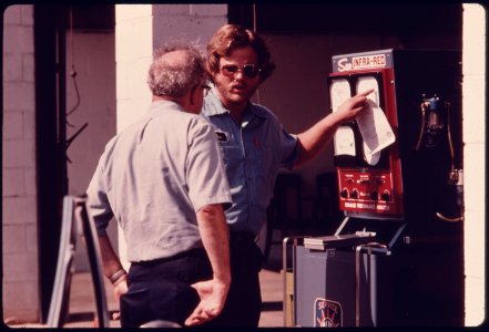 A Car Owner Reviews the Results of His Car's Inspection with an Employee of the Hamilton County Auto Emission Inspection Station at Newtown, Ohio...08-1975 (4266521106)