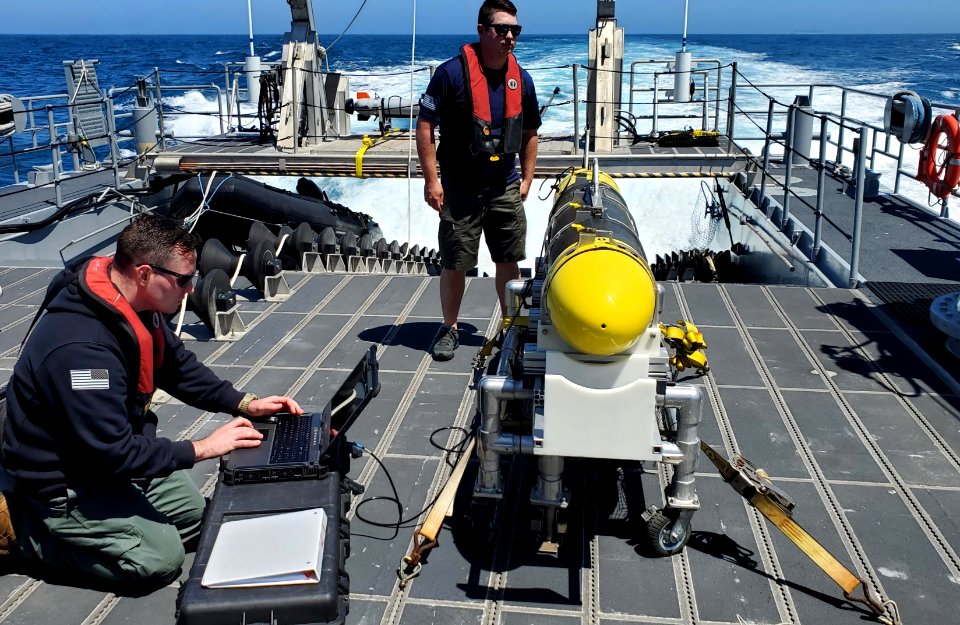 A CARINA undersea glider is prepared for launch aboard a multi-purpose craft