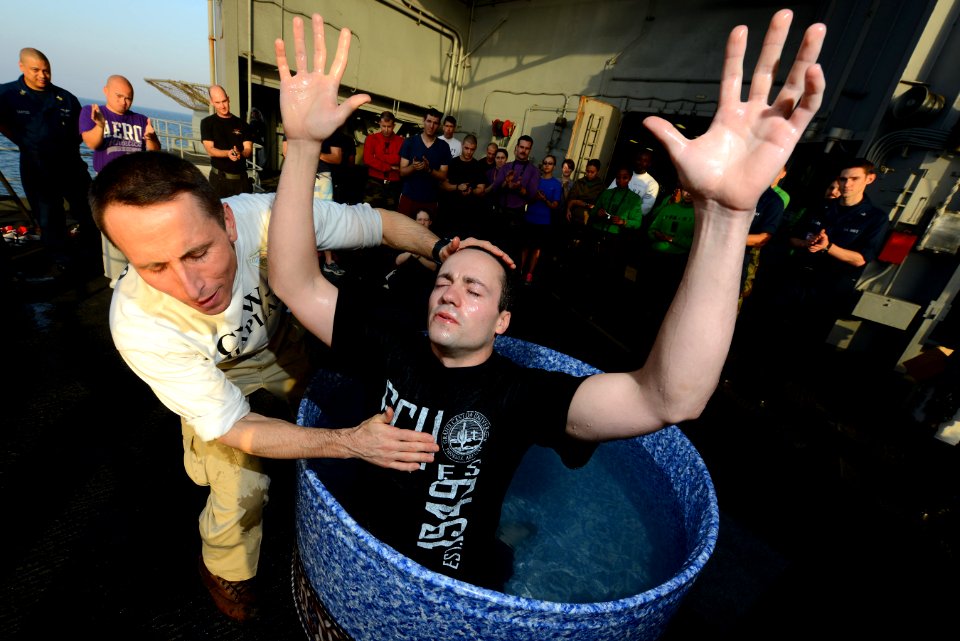 A chaplain baptizes a Sailor at sea. (8455084541)