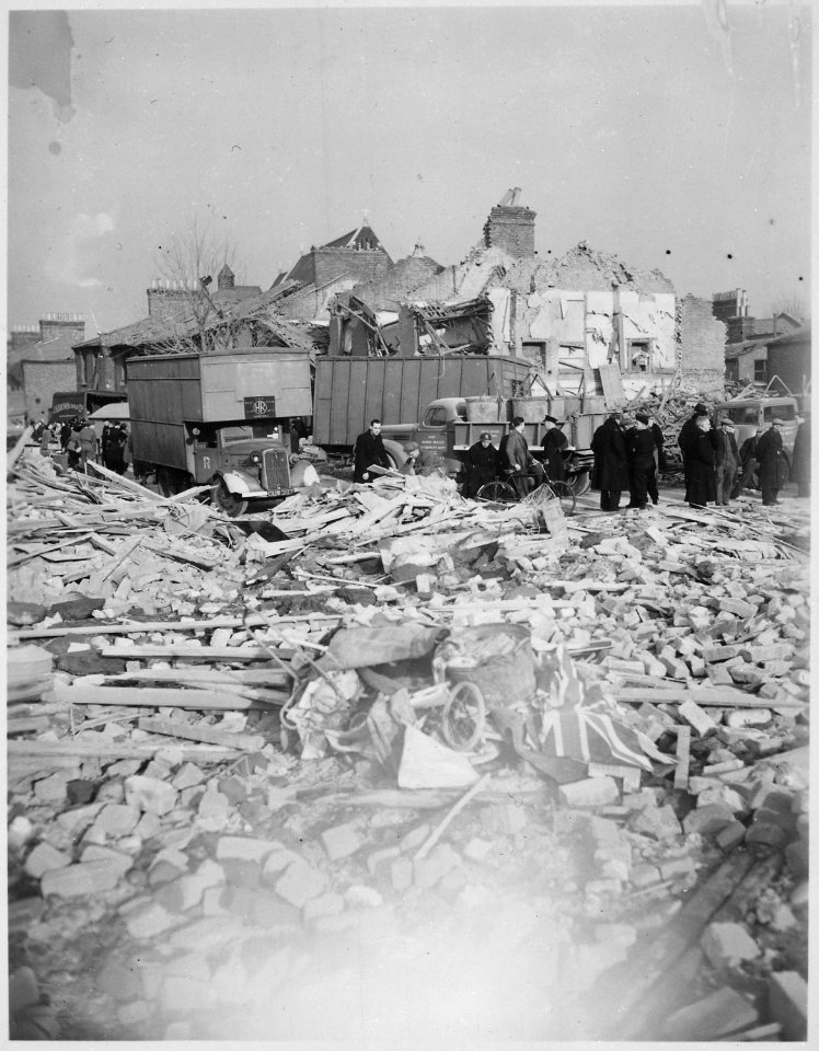 A British Flag lies among the rubble of homes smashed by the Camberwell Road Rocket explosion. V-bomb damage, London... - NARA - 540067