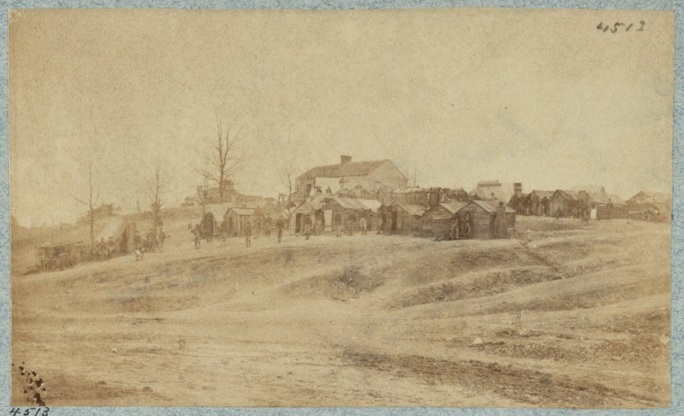 A camp made up of small cabins that surround a large building LCCN2014646007