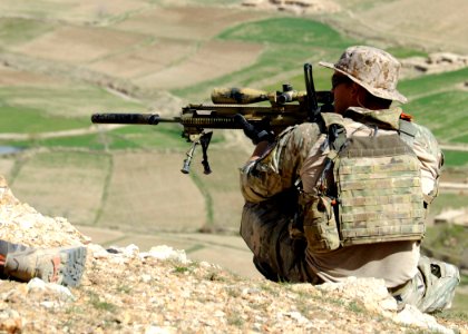A coalition Special Operations Forces member fires his sniper rifle from a hilltop during a firefight near Nawa Garay village (120403-N-MY805-202)