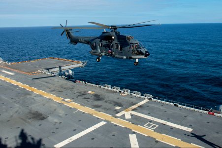 A Chilean Navy helicopter assigned to Helicopter Attack Squadron (HA) 1 prepares to land on the flight deck of the amphibious assault ship USS America (LHA 6) during a bilateral exercise in the Pacific Ocean 140827-N-MD297-154