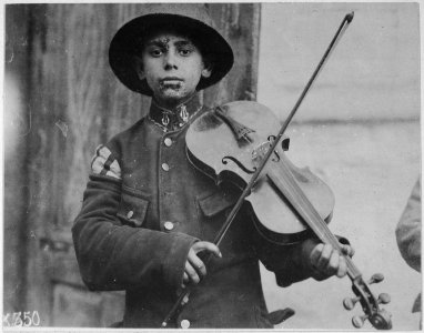 A Christmas street fiddler, Belgrade. Serbia (Yugoslavia), December 1918. American Red Cross., 1917 - 1919 - NARA - 533739