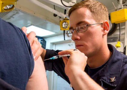 A corpsman gives vaccines. (21387634436)