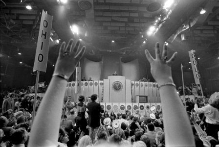 A Delegate Raises their Hands upwards While in the Crowd as President Richard Nixon Speaks from the podium at the Republican National Convention photo