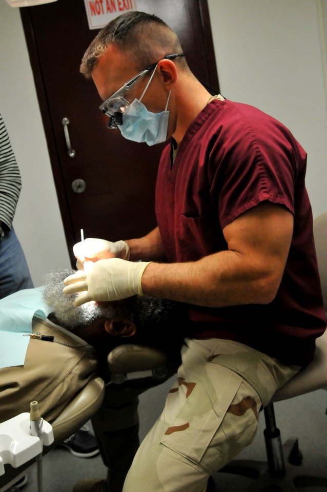 A dental officer cleans the teeth of a detainee at the medical department of Camp Six, Dec. 29, 2010. DVIDS355338