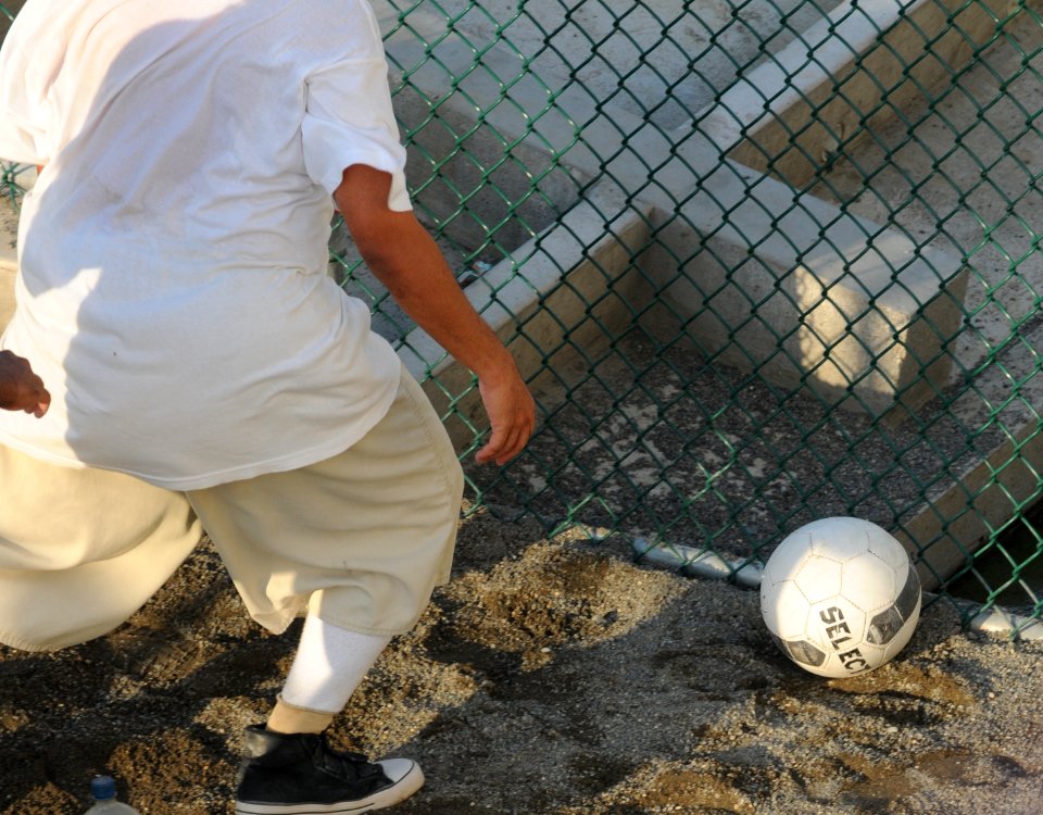 A detainee goes after a soccer ball within the outdoor recreation area of Camp Six at Joint Task Force Guantanamo DVIDS373570