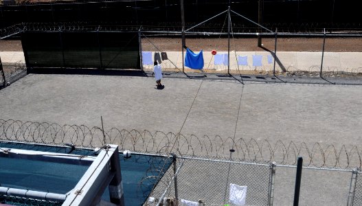 A detainee walks in the outdoor recreation area of Camp Six at Joint Task Force Guantanamo DVIDS380258 photo