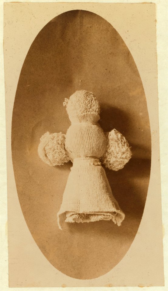 A doll made by one of the 5 year old children that plays in knitting mill where mother works. Made from waste material. These children help sister and mother ravel. LOC nclc.05385